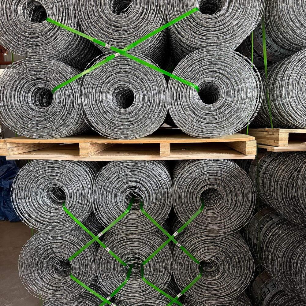 Palletized galvanized field fence rolls ready for export packing