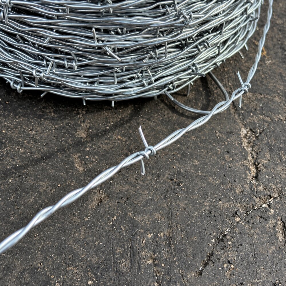 Close-up of galvanized 2-point barbs on two-strand twisted fence wire