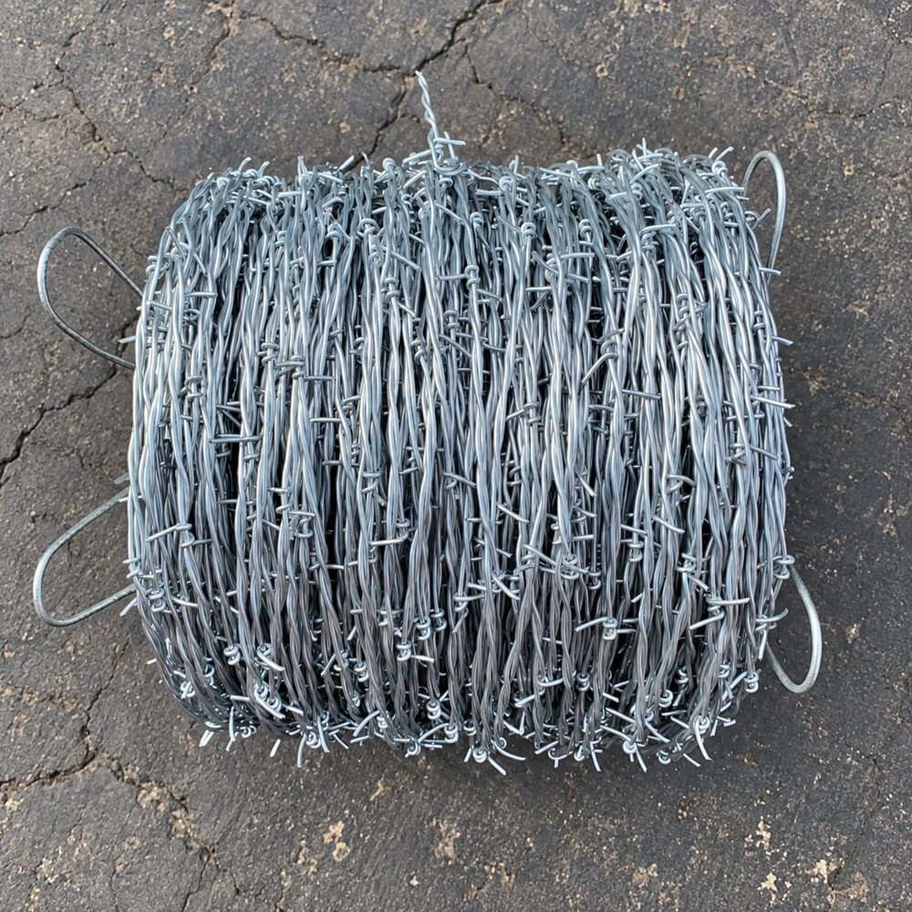 Top view of a bulk 12.5 gauge galvanized 2-point barbed wire coil