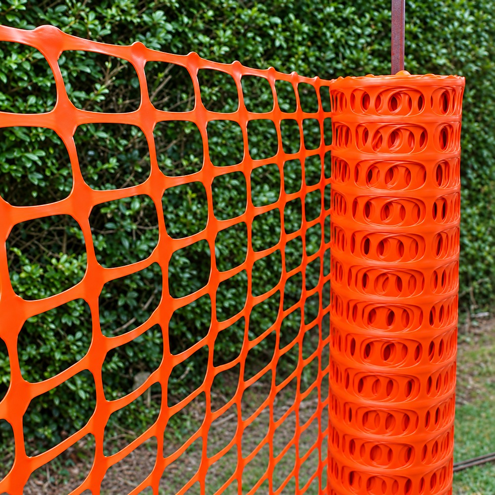 Orange square mesh safety fence roll outdoors